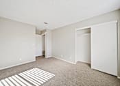 Thumbnail 7 of 13 - A room with a carpet and a white door.