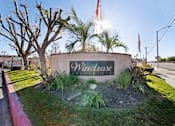 Thumbnail 1 of 13 - A sign that says Windrose is in front of a tree.