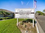 Thumbnail 1 of 15 - A sign for Cottonwood Spacious Apartment Homes with a leasing office at 8150 Cottonwood Ave.