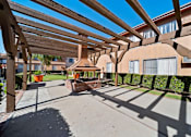 Thumbnail 16 of 70 - A wooden pergola over a walkway in a residential area.