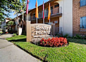Thumbnail 1 of 70 - The sign in front of the building says Sunset Pointe Apartment Homes.