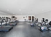 Thumbnail 31 of 70 - A gym with treadmills, exercise bikes, and other equipment.