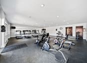 Thumbnail 32 of 70 - A spacious home gym with a variety of exercise equipment.