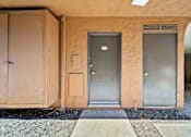 Thumbnail 35 of 70 - A building with a grey door and a brown door.