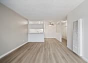 Thumbnail 41 of 70 - A room with light grey walls and wooden flooring with a white ceiling.