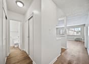 Thumbnail 50 of 70 - A white bathroom with wood flooring and a window.