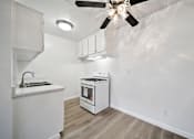 Thumbnail 70 of 70 - A kitchen with a white counter and a white oven.