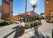 Thumbnail 7 of 70 - A sunny day in a residential area with a street leading to a house.