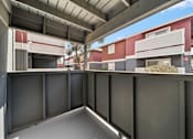 Thumbnail 11 of 13 - A modern building with a red and white facade and a grey roof.