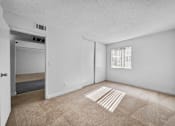 Thumbnail 7 of 13 - A room with a carpet and a window with blinds.