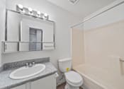 Thumbnail 13 of 21 - A bathroom with a sink, toilet, and bathtub.