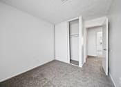 Thumbnail 4 of 21 - A room with white walls and a grey carpet.