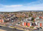 Thumbnail 15 of 21 - A view of a residential area with houses and cars.