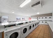 Thumbnail 18 of 21 - A row of washing machines in a laundromat.