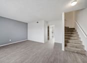 Thumbnail 14 of 21 - A room with a staircase on the right side.
