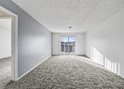 Thumbnail 8 of 21 - A room with grey carpet and white walls.