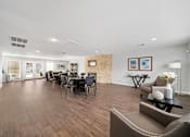 Thumbnail 11 of 17 - A spacious living room with a dining table and chairs.