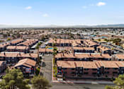 Thumbnail 6 of 17 - A view of a residential area with houses and a road.