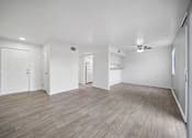 Thumbnail 15 of 17 - A room with wooden flooring and white walls.
