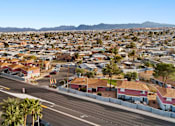Thumbnail 8 of 9 - A view of a residential area with houses and palm trees.