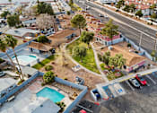 Thumbnail 5 of 9 - A parking lot with cars and a pool in the foreground.