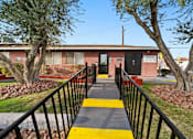 Thumbnail 7 of 9 - A building with a black fence and a yellow stripe on the ground.