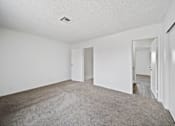 Thumbnail 9 of 11 - A room with white walls and carpeted floor.