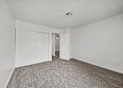 Thumbnail 10 of 21 - A room with a carpeted floor and white walls.