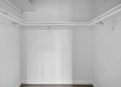 Thumbnail 18 of 21 - A white room with a grey carpet and white walls.
