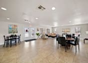 Thumbnail 14 of 21 - A spacious living room with a dining area and a kitchen in the background.