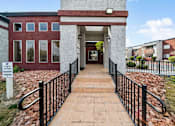 Thumbnail 11 of 21 - A brick building with a sign that says "Future Resident Parking" in front of it.