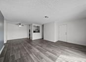 Thumbnail 2 of 21 - A room with a ceiling fan and a door.