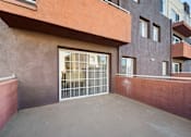 Thumbnail 15 of 75 - A building with a brown wall and a white gate.