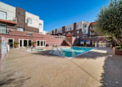 Thumbnail 16 of 75 - A large outdoor swimming pool surrounded by apartment buildings.