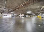 Thumbnail 19 of 75 - A spacious parking garage with multiple cars parked.