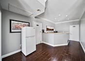 Thumbnail 28 of 75 - A kitchen with white appliances and wood floors.