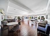 Thumbnail 29 of 75 - A spacious room with a round table and chairs.