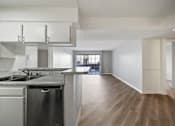 Thumbnail 47 of 75 - A kitchen with a granite countertop and stainless steel appliances.