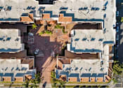 Thumbnail 4 of 75 - A parking lot is surrounded by a concrete building.