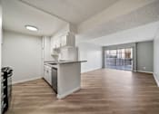 Thumbnail 52 of 75 - A kitchen with a white countertop and wooden floors.