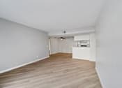 Thumbnail 54 of 75 - A room with wooden flooring and white walls.