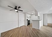 Thumbnail 58 of 75 - A room with a ceiling fan and wooden flooring.