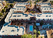 Thumbnail 5 of 75 - An aerial view of a building with a pool in the middle.