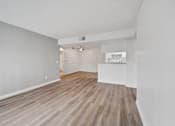Thumbnail 61 of 75 - A room with wooden flooring and white walls.