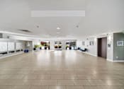 Thumbnail 62 of 75 - A spacious room with a tiled floor and white walls.