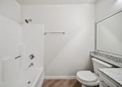 Thumbnail 64 of 75 - A white bathroom with a toilet, sink, and bathtub.