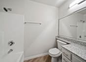 Thumbnail 65 of 75 - A white bathroom with a toilet, sink, and shower.