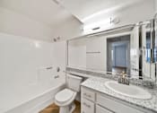 Thumbnail 69 of 75 - A white bathroom with a toilet, sink, and bathtub.