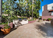 Thumbnail 6 of 75 - A courtyard with a concrete floor and a wall with a window.