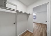 Thumbnail 73 of 75 - A white door with a black handle is in a room with white walls and wood flooring.